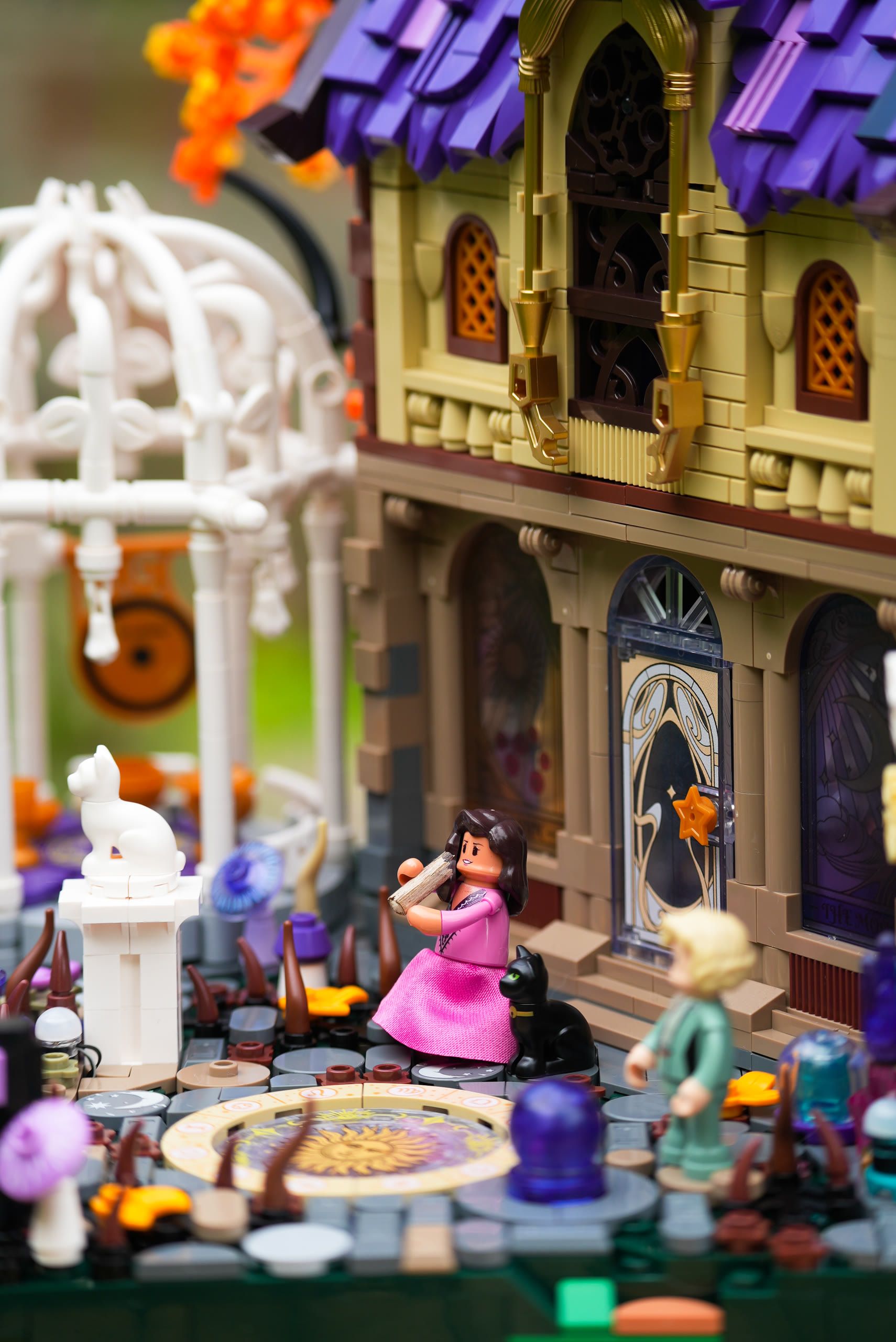 A building-brick scene with a minifigure playing the flute outside a fairytale house